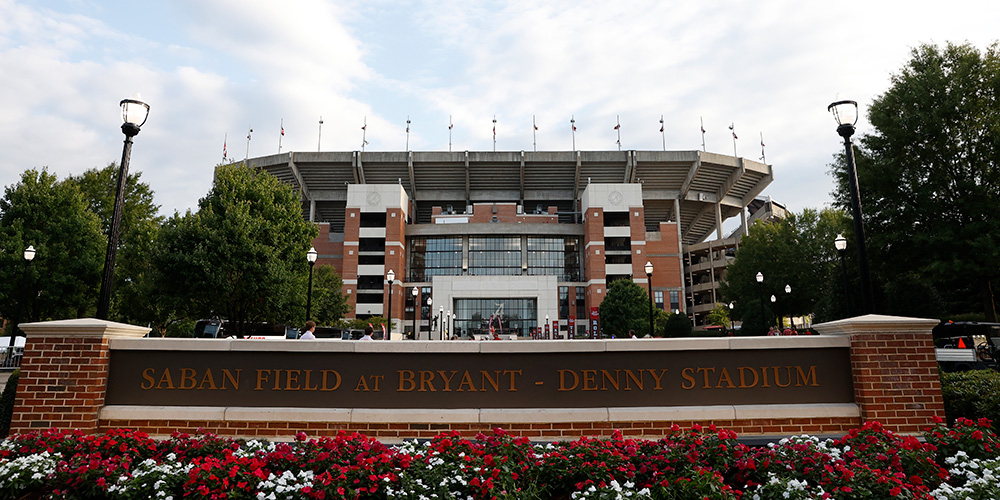 Sign outside of Saban Field at Bryant-Denny Stadium with the stadium in the background